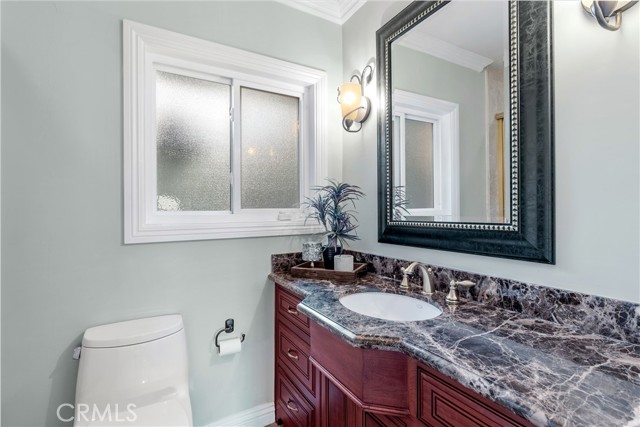 Hallway Bathroom with elegant finishes and shower in tub.
