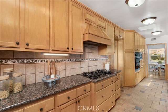 Kitchen opens to the dining room and den.