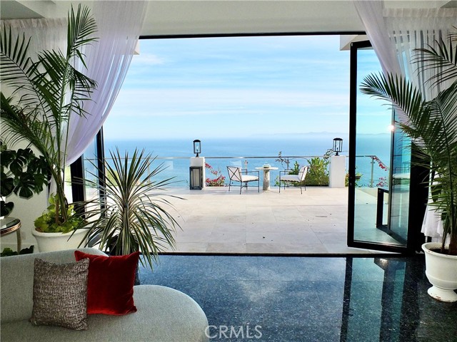 German Trifold Glass Doors Open to the Pacific's Panoramic Views