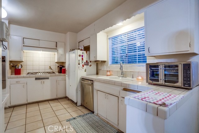 Spacious Kitchen with tile counter tops and flooring