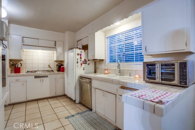 Spacious Kitchen with tile counter tops and flooring