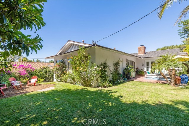 Lots of outdoor space with grass yard, mature landscaping, blooming colors everywhere!