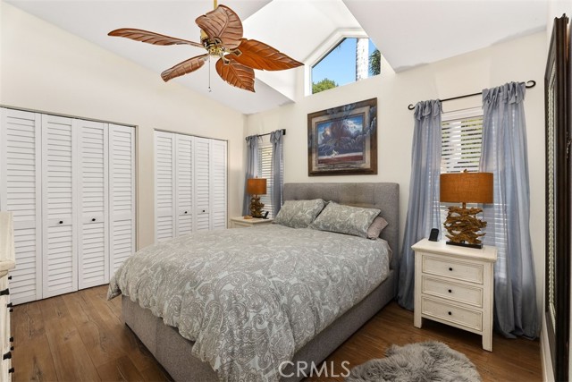 Spacious primary bedroom with high ceilings and natural light