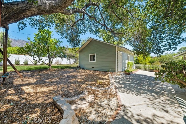 Shaded yard space behind garage.