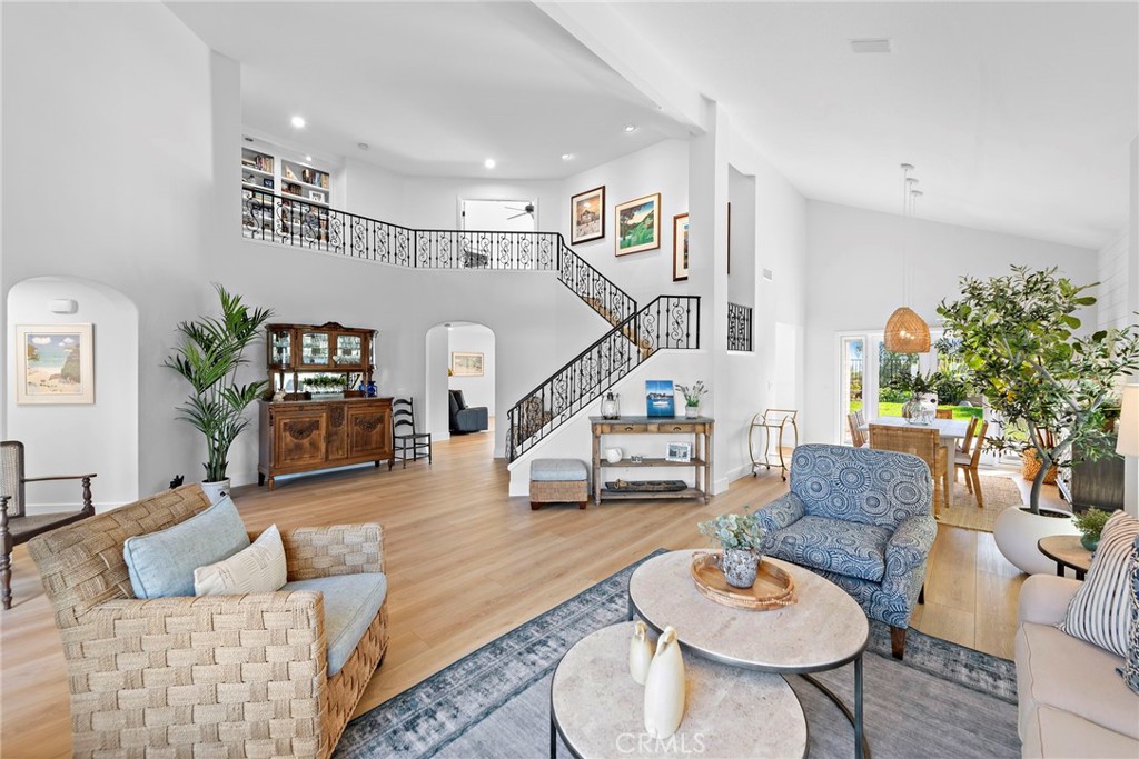 Step into coastal elegance with a modern twist in this stunning Palisades, Laguna Heights home. With coveted southern exposure and stunning views of the surrounding hills, including a peek of the ocean, this residence embodies relaxed refinement, offering a soothing interior and comfortable living spaces. Remodeled just 13 months ago, this home boasts brand-new LVP plank flooring throughout most of the home, a sleek modern kitchen equipped with a center island, top-of-the-line appliances, and charming shiplap detail in the formal dining room, complemented by Serena & Lily light fixtures. The main floor bedroom is complemented by a beautifully remodeled bathroom with a walk-in shower. Upgrades abound with Milgard dual-pane windows, custom blinds, PEX piping, and a newer HVAC system. Upstairs, the primary suite is a serene retreat, boasting separate his and her closets and French doors that lead out to a rebuilt deck furnished with composite deck boards. Indulge in a remodeled bathroom with a dual sink vanity, soaking tub, and walk-in shower. The upstairs guest bedrooms share a modern coastal-style bathroom. All closets have been equipped with professional organizers for optimal organization. The expansive rear yard, boasting views of the surrounding hills, features a built-in BBQ, a covered patio, and ample space for a pool should you opt to install one. The Palisades community is known for its generous lots, low HOA dues, wide streets, and top-tier schools. Residents enjoy easy access to two community pocket parks, hiking, and biking trails within the nearby 16.5-acre Chapparosa Park, which provides a direct trail to Salt Creek Beach