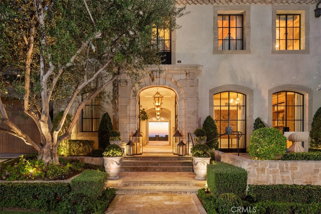 Settling for less isn’t an option at this absolutely stunning villa on the sand at The Strand at Headlands in Dana Point. Unobstructed front-row views span the azure Pacific Ocean, crashing waves, southern Orange County’s golden coastline, Catalina Island and the imposing headlands of historic Dana Point. Every level of the custom estate opens to the ocean, welcoming fresh sea breezes, natural light, and the hypnotic sounds of the surf into nearly every room. Extending approximately 10,576 square feet, the bespoke oceanfront mansion redefines elegance and sophistication with uncompromising craftsmanship and unyielding attention to detail. Heated limestone floors throughout add to the luxurious ambiance of the home. An appropriately grand entrance leads to a floating circular staircase that is crowned by a glass ceiling on the third level and provides a dramatic focal point on every floor. An elevator also serves each level of the home, which hosts five ensuite bedrooms and 7 full and 2 half baths. The formal foyer leads to a chic parlor, a formal dining room, and a massive great room with fireplace. Disappearing glass pocket doors open the great room to a large loggia that showcases a floating cantilevered spa with acrylic bottom that overlooks the beach. An island kitchen features a nook with built-in seating, and a separate catering kitchen and service bar. Take the stairs or elevator up to the top floor, where bedroom suites include a five-star owners retreat with sitting area, fireplace, ocean-view balcony, an oversized walk-in closet with island, and an exquisite bath. It’s all about fun and entertainment on the lowest floor, where a game room, billiards room, glass-enclosed wine cellar, service kitchen, fifth bedroom and a gym are located. This floor opens via a disappearing glass wall to a loggia with massive sunken wet bar. Beyond the bar awaits a resort pool and spa, a built-in island with grill, a seating area with open-air fireplace, extensive stone decking and direct beach access. Created by Homer Oatman of Oatman Architects, the estate was built by Mike Reeves of Corbin Reeves Construction and reveals exceptional interior design by Ohara Davies-Gaetano. Sequestered behind guarded gates, The Strand at Headlands is one of the most coveted oceanfront communities in California and offers more than one mile of coastline, 70 acres of parks, scenic trails, a beach club and easy access to resorts, shops, restaurants and outstanding schools.