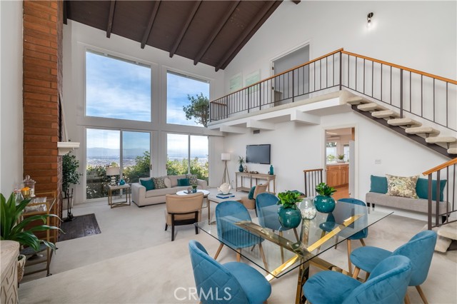 Dining and living room with floor to ceiling view