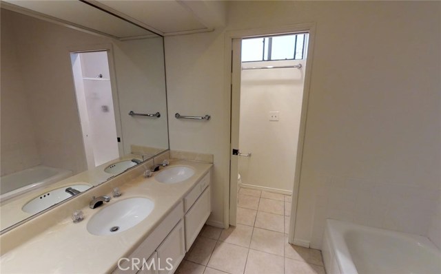 Master bathroom with double sinks,separate shower/tub, and toilet closet