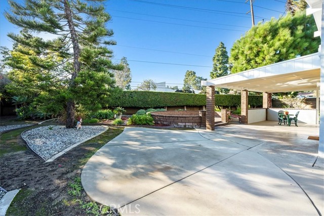 Large yard has mature trees, in ground spa and lots of patio areas