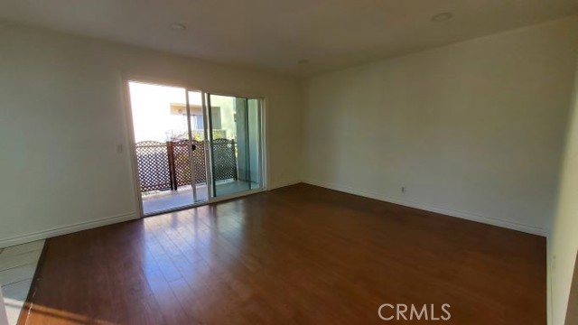 Spacious living room leads to good size balcony and storage room