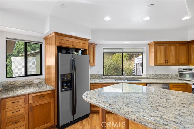 338 Y - Kitchen feature breakfast bar, abundant wood cabinetry and premium stainless steel appliances.