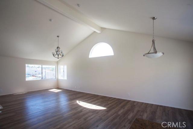Living room is very bright with city lights and hills view