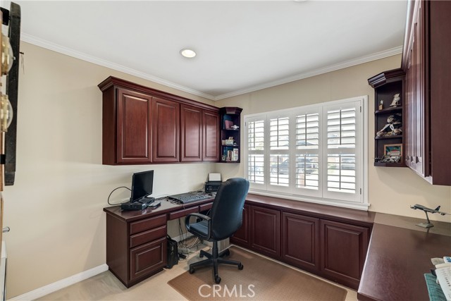 bedroom with builtins used as an office