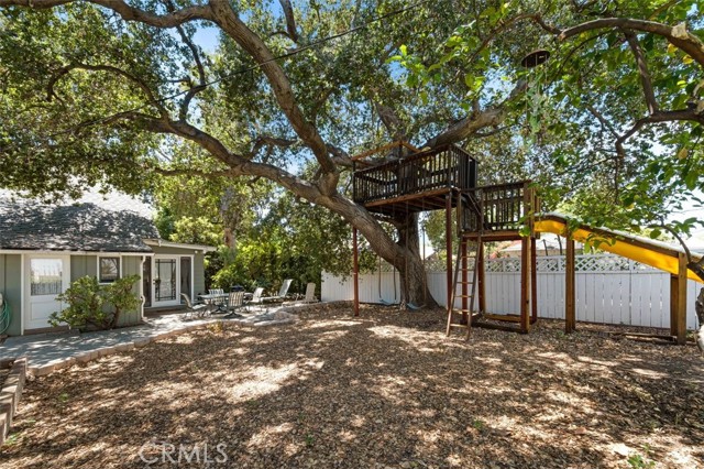 Outside entrance to home office on left, family room french doors on right. All day shade from gorgeous oak tree.