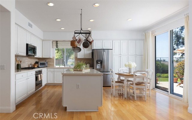 Beautiful kitchen with white cabinets, stainless steel appliances, and an island.