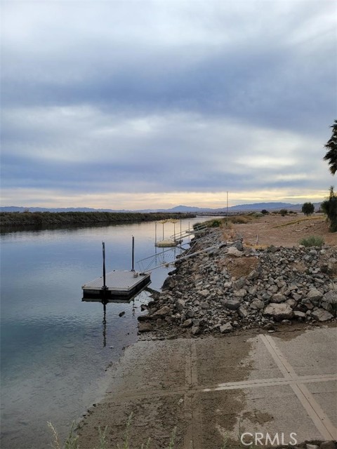 This riverfront property is a rare find. That is, there are very few remaining riverfront parcels of this size available on the Colorado River. Consisting of 4.28 acres with 165.5 linear feet of waterfront, this property has in place some expensive improvements. For example, the property has a well, electricity, boat dock, boat launch ramp, and a concrete slab with a shaded built-in patio area and BBQ. This beautiful location is perfect for the construction of a river home, or for multiple homes, as the site allows for as many as four homes per local building code.This riverfront property is a rare find. That is, there are very few remaining riverfront parcels of this size available on the Colorado River. Consisting of 4.28 acres with 165.5 linear feet of waterfront, this property has in place some expensive improvements. For example, the property has a well, electricity, boat dock, boat launch ramp, and a concrete slab with a shaded built-in patio area and BBQ. This beautiful location is perfect for the construction of a river home, or for multiple homes, as the site allows for as many as four homes per local building code.