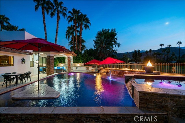 2081 S Bobolink Lane Palm Springs, California Attention investors! This South Palm Springs property is a proven and currently successful vacation rental in the last two years that has produced between $180k to $220k in consistent rental income annually. Neighborhood is still within its limits and is short term rental eligible! Golfers, investors, full or part timers and desert lovers search no more, this is the home of your dreams on Tahquitz Creek Golf Course Resort. Best of all, no HOA fees and on Fee land! This spectacular resort features two 18-hole courses both offering amazing views of the San Jacinto Mountains. An iconic city like Palm Springs deserves a one-of-a-kind home and this lovely 5 Bedroom, 5 Bath (including private Casita!) checks all the boxes. Boasting breathtaking, unobstructed (no wires) West facing mountain views elevated by a private rooftop deck reached by a lovely outdoor spiral staircase. An amazing pebble-tec saltwater pool with built in swim-up bar and a raised jacuzzi surrounded by wonderous fire features and waterfalls that provide a surreal, unforgettable ambience. The inside of the home is just as fabulous with 2 primary suites each with their own fireplace, 2 guestrooms with a jack and jill bathroom. The open space kitchen with an island granite top provides an amazing view to the warm loving San Jacinto peaks. The double living room features a grand high ceiling with exposed beams, recessed lighting and its own fireplace with a limestone flooring across the home. The theatre/game room features an all-around experience with its own sunken wet bar, pool and foosball tables, a surround sound system with state-of-the-art projector and screen to truly enjoy a cinematic experience in the comfort of your own home. Last of all car lovers, this home provides a very spacious 2 car garage and ample RV parking for you to park all your toys. Other features of this home include: 3 HVAC units, 2 new and 1 recently maintained, leased SOLAR for green energy efficiency, travertine floors, granite countertops, oak cabinetry, walk-in closets, smart home features throughout, installed sound system, 2 water heaters, alarm system, pool heater and all appliances included. This jewel villa must be experienced in person to appreciate its magnificence. Come and enjoy all that this stunning, desert villa has to offer. Schedule a showing today!