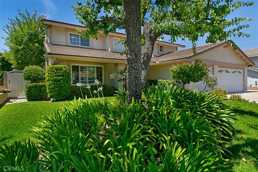 This lovely 4 bedroom 2.5 bath home was recently recognized as a 2019 Glendora Beautiful award winner for its inviting front yard appeal. The back yard is artistically landscaped and includes a waterfall feature, large covered patio, 3 ceiling fans, retractable shades and a view of the mountains making it a wonderful retreat.
Step inside this home to a welcoming entryway with vaulted ceiling and tile flooring. The living room opens to a dining room area both upgraded with crown molding and plantation shutters. The kitchen has been beautifully remodeled with custom solid maple cabinetry, a custom built island and granite counters. The spacious kitchen includes an area perfect for a kitchen table which feeds into the family room complete with crown molding, a painted brick fireplace, tile floor, etched glass sliders leading to the back yard, and a charmingly remodeled 1/2 bath just off of the family room.
Upstairs are 4 spacious bedrooms including the master bedroom with ensuite bathroom, The 3 other bedrooms are roomy and generously sized., A whole house fan , along with gradient barrier insulation installed in the attic, electric retractable exterior shades on the rear facing windows and central AC helps keep the home fresh and cool.