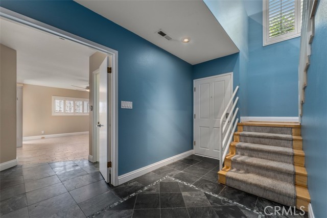 Unit 1 entry. Stairs to living space on the right and door to the bedroom suite on the left.