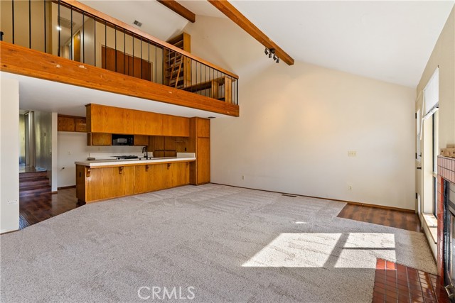 With a high vaulted ceiling, the living room opens upward to lovely clerestory windows.