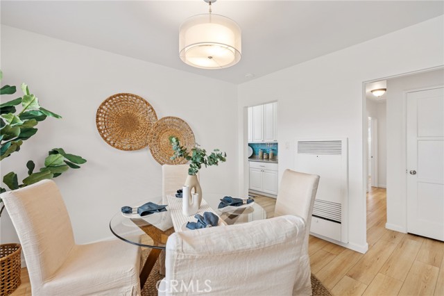 Dining area leading to kitchen area and down the hall to the 3 bedrooms.