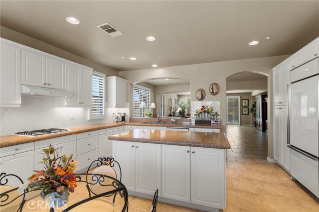 Large luxurious kitchen with open concept to dining area and living room