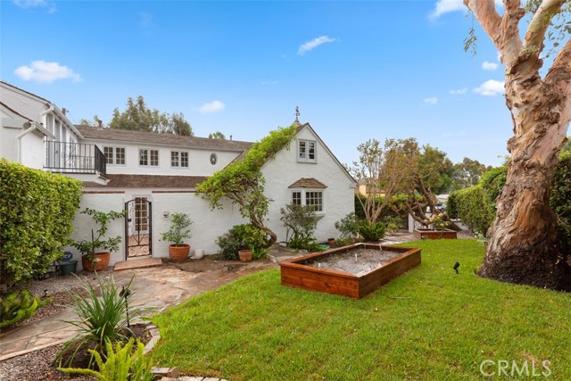 PRIVATE FRONT YARD WITH MATURE TREES , GRASS AND GARDENING BINS