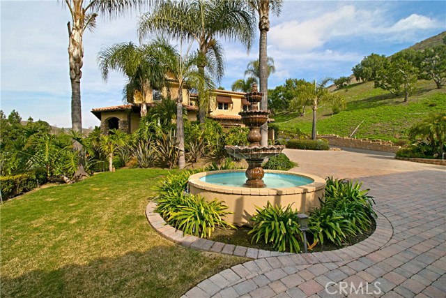 The circular driveway between the main house and the casita is paved with an ornate fountain adding to the Romantic Tuscan ambiance.