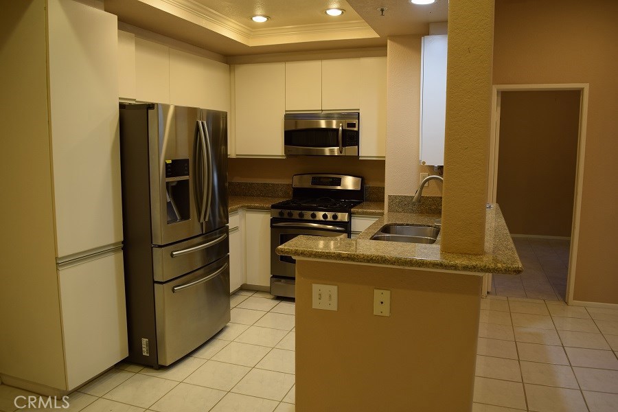 Come home to this beautiful 2 bedroom and 2 baths lower unit. Kitchen with granite countertops, stainless steel appliances. master bathroom with remodeled shower. Family room with a romantic fireplace and nice size patio perfect for entertaining guests. This home offers one car detached garage and an assigned parking space. This community offers two pools, a spa, a gym, and greenbelts. You don't want to miss this one.