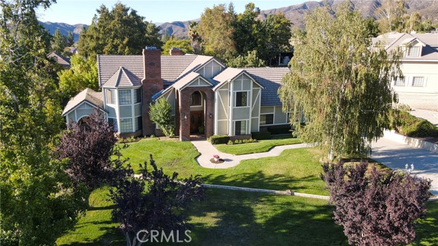 13689 Oak Mesa Drive Yucaipa, California First Time on the Market!! Welcome to this Exquisite Hidden Meadows Tudor, Featuring 4 Bedrooms, 3-1/2 Baths, 3-Car Garage on a Pool-Size Yard. The Detail of Brick and Wood Trim Adorns this Freshly Exterior Painted Home. You will be Wowed by the Elegant Leaded Glass Window Over the Entrance Door. From the Formal Foyer to the Right is a Spacious Bedroom with its Ensuite Full Bath. The Comfortable Family Room Boasts a Large Brick Wood-Burning or Gas Fireplace and a Well-Appointed Wet Bar for your Enjoyment. Further Ahead is the Eat-in Kitchen Dining Area with a Built-in Desk and a Wall of Cabinet Space. The Kitchen is Spacious with all Appliances Included, a Bay Window to Watch the Hummingbirds in the Morning. The Cranberry-Colored Formal Dining Room will Accommodate your Loved Ones for the Upcoming Holidays. Next, is an Office with Built-in Shelves and a Large Window for Natural Light. The Step-Down Formal Living Room with a Fireplace is a Great Place for the Whole Family to Gather. Additionally, you will Find a Large Laundry/Utility Room with Ample Counter Space and More Cabinets. Upstairs are Two Additional Bedrooms and a Full Bath. You'll Enjoy the Open Bonus Room with a Fireplace it is the Ideal Game Room. Lastly, the Spacious Main Room with a Retreat, Walk-in Closet and Ensuite Bath. This Home is Perfect for Entertaining Both Inside and Out. The Meticulous Park-Like Setting Backyard Affords Endless Possibilities. Low Property Taxes and No HOA. Preview this Amazing Home Today!!