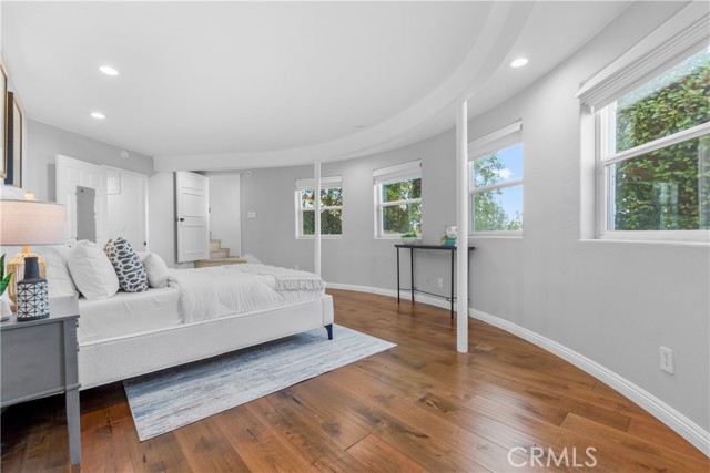The elegant primary bedroom is a spacious suite where the Art Deco design continues.