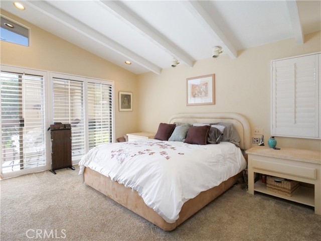 Primary Bedroom #1 with custom shutters and high beam ceilings