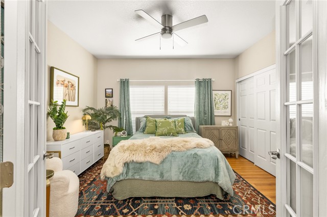 Secondary bedroom with french doors, newer ceiling fan and double closets.