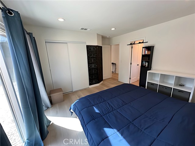 ADU bedroom 1 with recessed lighting and lots of natural light