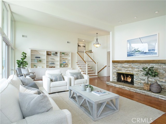 Living Room with fireplace, built-in cabinetry and ocean view.