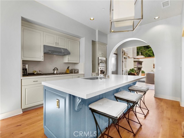 Fully appointed gourmet, dine-in kitchen with french door leading to a sweeping outdoor patio.