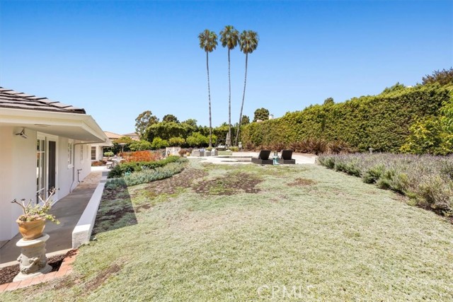 Huge yard beyond the pool area is planted with drought tolerant plants.