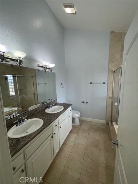 Primary Bathroom with dual vanity, walk in shower and jetted tub