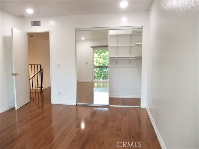 Bedroom with mirror closet door