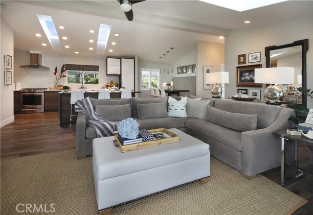 Living room view towards gourmet chef's dream kitchen, oversized island with seating & storage and built-in dining area.
