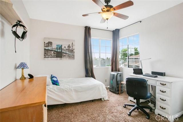 Corner French-glass windows provide an overlooking view of the neighborhood on this 2nd Floor Bedroom.