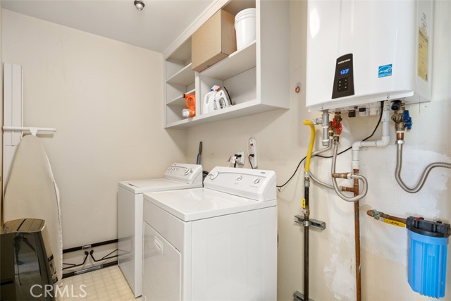 separate upstairs laundry room with oversized tankless water efficiency water heater