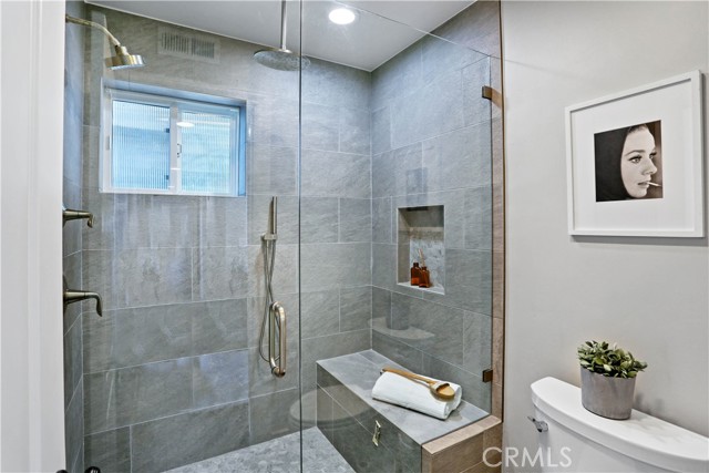 Downstairs Bath with Multiple Shower Heads and Seat.