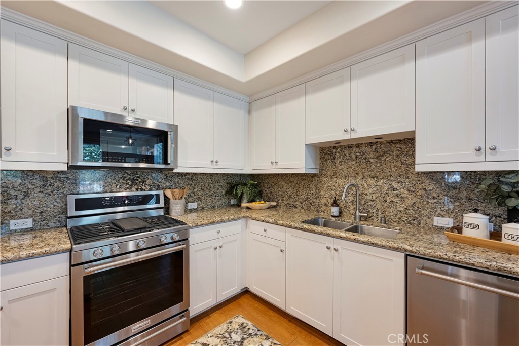Neutral tones, Large Stainless Steel Sink, and tons of counter space round out this beautifully upgraded Kitchen!