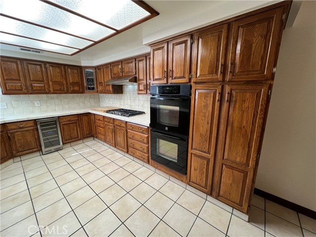 Double ovens - stove top - wine cooler with two cooling features.