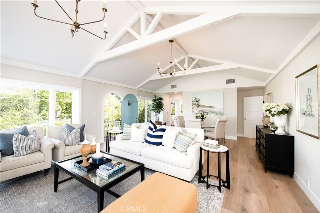 Nestled on a peaceful street in the coveted enclave of Woods Cove, 567 Flora is a beautifully reimagined four-bedroom residence that creates an environment of modern sophistication with timeless charm. Meticulously renovated with uncommon design elements and exceptional craftsmanship, this single-level home offers a rare and thoughtful floor plan, with all bedrooms conveniently situated on one level. From the moment you step inside, natural light pours through large windows, illuminating high vaulted ceilings and showcasing curated architectural details throughout. The main living area is anchored by a striking fireplace and expansive picture windows showing ocean views, creating a serene and elegant backdrop for everyday living. The primary suite is a private sanctuary, featuring a luxurious spa-inspired bath with a generous walk-in shower, an oversized soaking tub, and a spacious walk-in closet. French doors open to a charming, secluded patio—perfect for enjoying morning coffee while taking in the glimmer of the Pacific beyond. Each bedroom in the home enjoys direct outdoor access, from a shared deck between two rooms to a quiet side terrace adjacent to the office, offering the quintessential California indoor-outdoor lifestyle. At the heart of the home, the stunning chef’s kitchen boasts high-end appliances, custom-milled cabinetry, and pristine Calacatta marble countertops and backsplash. An oversized eat-in island invites gatherings both intimate and grand. Throughout the interior, clean shiplap detailing lends a fresh, coastal-chic aesthetic that is both relaxed and refined. Even the garage has been thoughtfully considered—with sleek new epoxy flooring and a full bath, it offers the flexibility for use as a studio, gym, or creative space. Sitting on a quiet street, the birds chirp softly and the wind flows gently at 567 Flora.