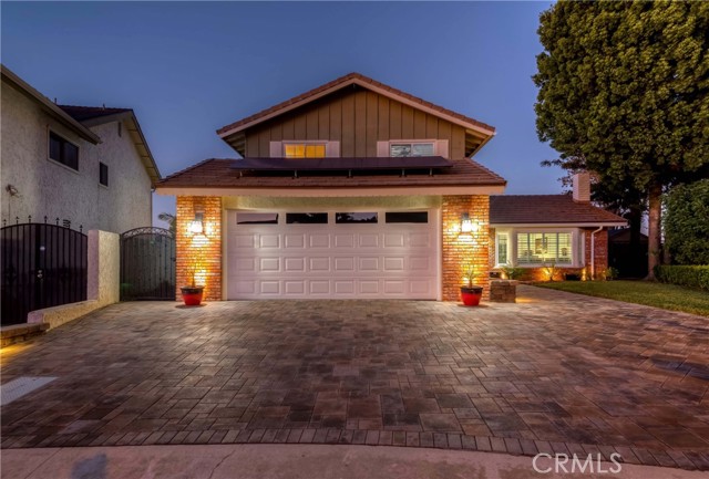 Luxury living in the prestigious city of La Habra in one of the most high in demand neighborhoods! Gorgeous Remodeled Home w/stunning custom hardscape curb appeal nestled on a quiet Cul De Sac! Offering PAID OFF SOLAR, 4 Bed & 3 bath layout, appx. 2,280 sq ft of abundant living space on a 7,200 sq ft lot! Main floor consists of a formal living room w/vaulted ceiling & cozy fireplace, formal dining room w/accent light fixture, elegantly remodeled w/granite countertop, subway tile backsplash, chic white cabinets, kitchen aid built in gas range/hood, double convection oven, dishwasher, microwave, oversized stainless steel double kitchen sink, tray ceiling w/recessed lighting, plus gorgeous city view from the kitchen window! Kitchen opens up to dining nook & family room w/cozy fireplace & dry bar, private laundry room, plus main floor bed & bath! Main floor bedroom currently being used as a convenient home office. Make your way to the second level, Master suite with walk-in closet, ceiling fan, city lights & mountain view, and sliding barn door to elegantly remodeled en-suite bath with oversized shower w/marble shower, double head shower fixtures, mosaic shower pan, granite counter dual sinks & bidet! 2 more bedrooms upstairs both generously sized & share an oversized remodeled hallway bath! Nicely sized backyard is perfect for entertaining with custom hardscape, above ground spa, city view, utility shed & lush greenery! On top of it all BONUS FEATURES; PAID OFF SOLAR (at times receives credit), Elegant wood tile flooring, remodeled kitchen & bathrooms, wrought iron staircase, dual pane windows, plantation shutters, recessed lighting, ceiling fans, custom hardscape, 3 car garage w/direct access & So Much More! Home is centrally located near Westridge golf course, dining, shopping, schools, parks, entertainment & easy freeway commute! Don't miss this once in a lifetime opportunity!!