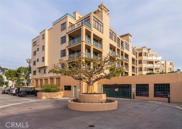 View of Seascape Two with guest parking and gated garage entrance