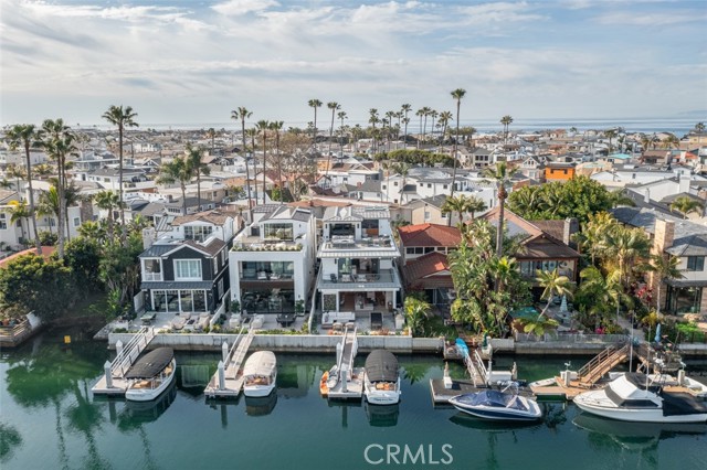 The only Newer Construction, Single Family Residence on the Waterfront with a private dock in Newport Beach listed under $9 million.  This is the waterfront home for the discerning buyer looking for the utmost craftsmanship in building standards. Located on Newport Island, 3904 Channel is the perfect culmination of design, function, and location. Completed in 2020 and minimally lived in as a second home, this home is built by premium builder Patterson Custom Homes, designed by highly sought-after Brandon Architects, and with interior designs from Denise Morrison.  A home of this caliber rarely comes to market and never at this price point.  The combined trio of talents has resulted in the most beautiful home with only the highest quality finishes and no expense spared. This all-en-suite 3 bed, 4.5 bath, three-level home, equipped with an elevator to all floors, has an open concept main floor living with floor-to-ceiling windows overlooking your waterfront bay views. Enter your generous outdoor space with a built-in barbecue, outdoor dining seating, and a new sea wall to accommodate your private dock fitting an approximate 35' boat vessel. In addition, you will enjoy two rooftop outdoor living spaces (not included in the square footage, one which is covered) on the third floor, accessible via elevator or an elegantly designed wood-slatted millwork staircase. Overlooking the bay with water and city views, the rooftop includes a wet bar, a fridge, custom cabinetry, a tile backsplash, seating, and a fire pit. Want to take a soak in the hot tub? Enjoy a rooftop jacuzzi overlooking the Peninsula with a chaise lounge seating area for relaxing. Built to the highest standards and master craftsmanship, the home automation system includes Control4 System, video surveillance, and Vantage Lightning System. Minutes from the beach and famed Lido Village, the location of 3904 Channel makes it easily accessible via bike or walking to all your favorite restaurants and shopping. The sellers recently renewed a one-year Platinum Level Custom Home Care package, which ensures the homeowner routine maintenance on your custom home. The home was also featured in the 2021 Newport Harbor Home Tour and is available fully furnished.