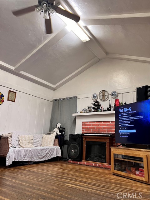 Living Room, high ceiling, fan & fireplace